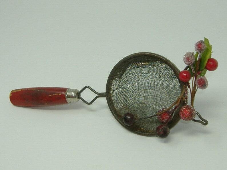 OOAK Christmas Decoration Made From Vintage Wooden Red Handle Utensil. Ornament made from upcycled red handled strainer.